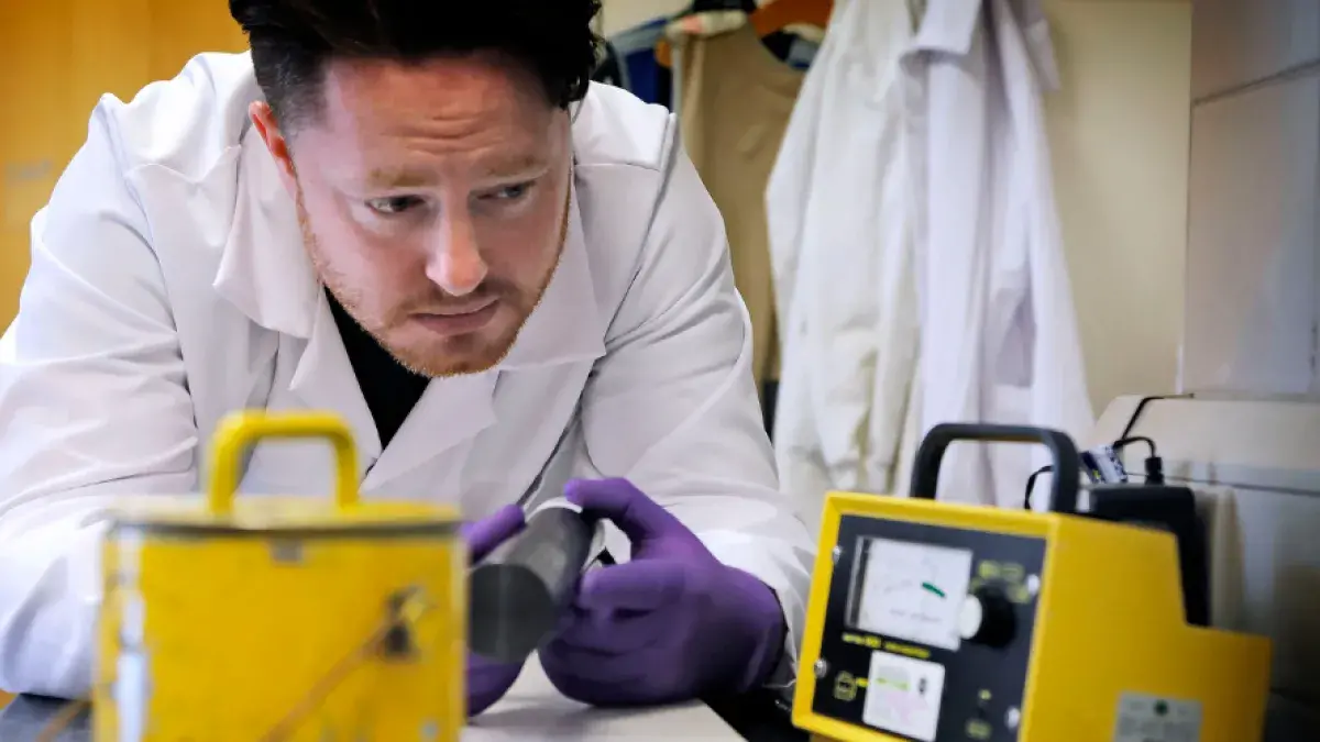 A member of the radiation unit inspects equipment