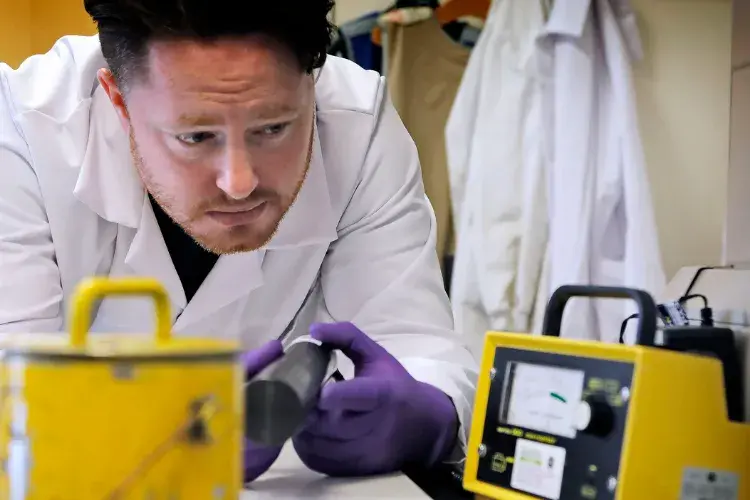 A member of the radiation unit inspects equipment